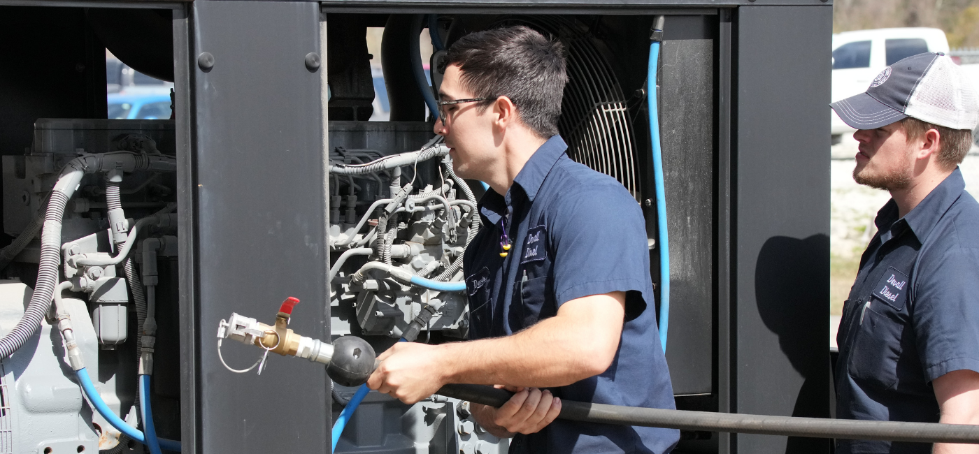 A Devall Diesel technician performing maintenance on a generator