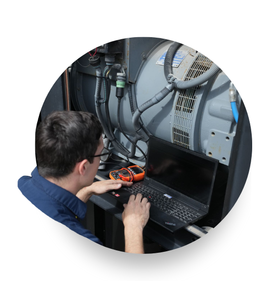 A Devall Diesel technician working on laptop