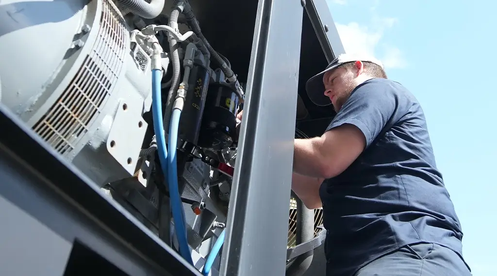 A Devall Diesel technician installing a diesel engine