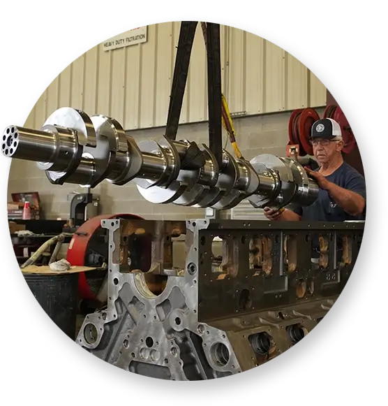 A Devall Diesel technician taking apart a large diesel engine